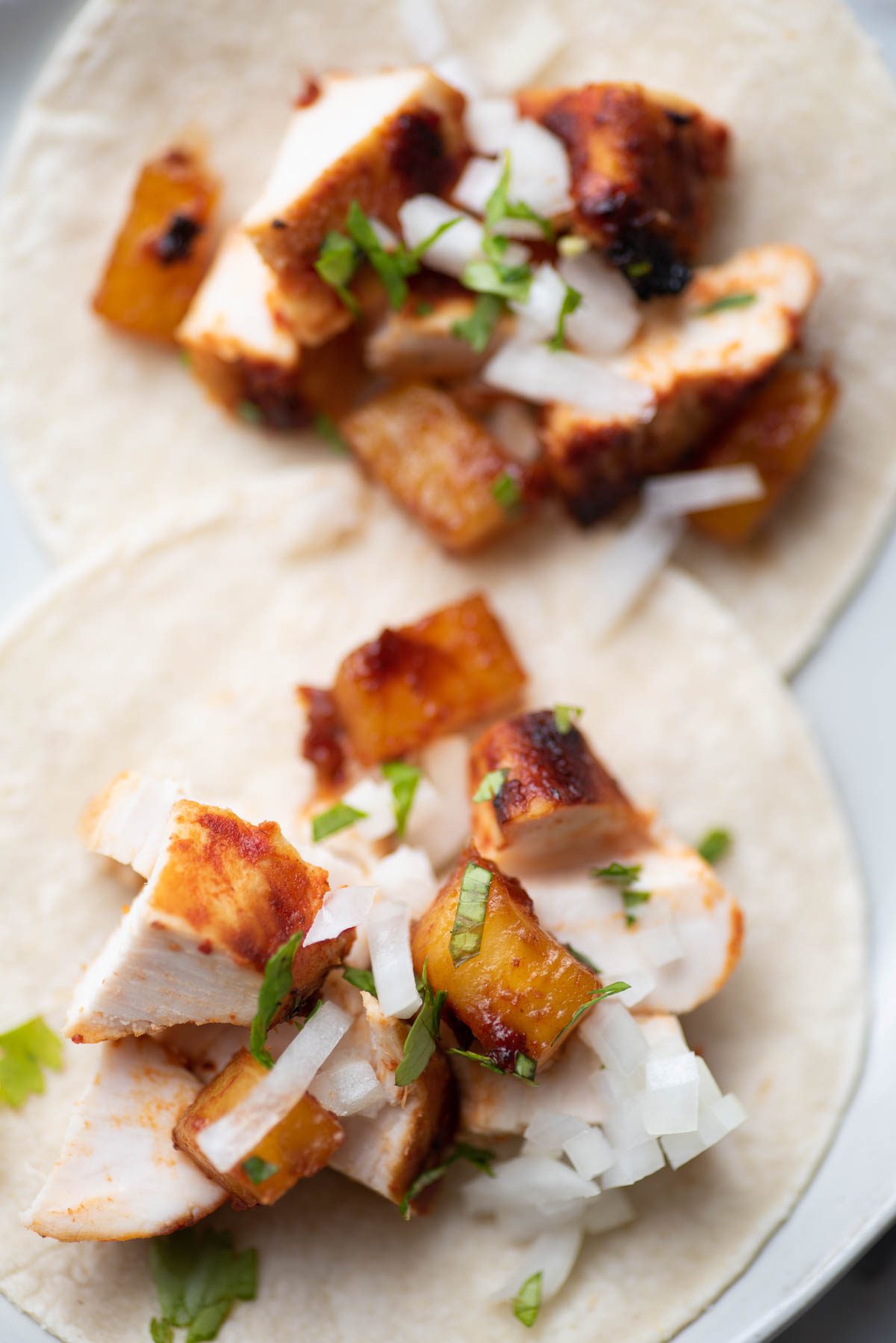 chicken tacos with cilantro and onion and pineapple.