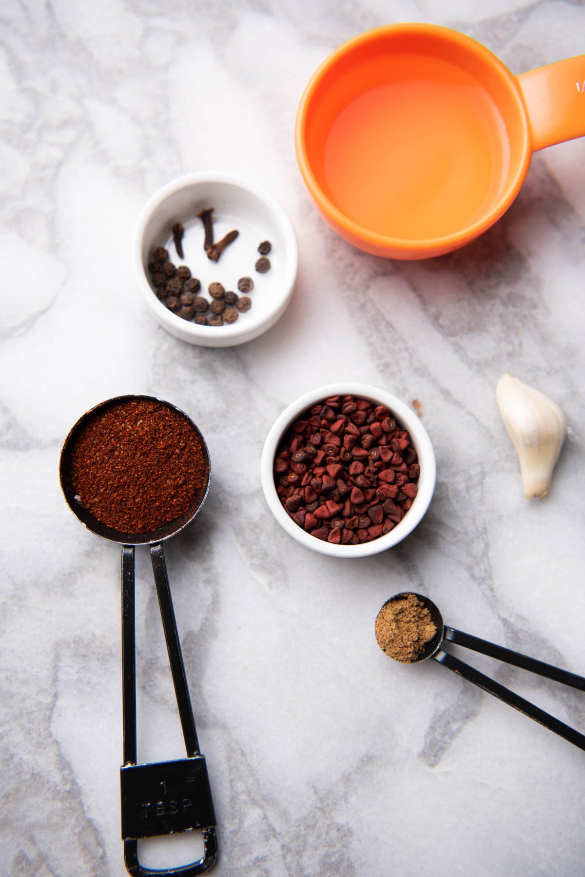 Achiote ingredients on white counter.