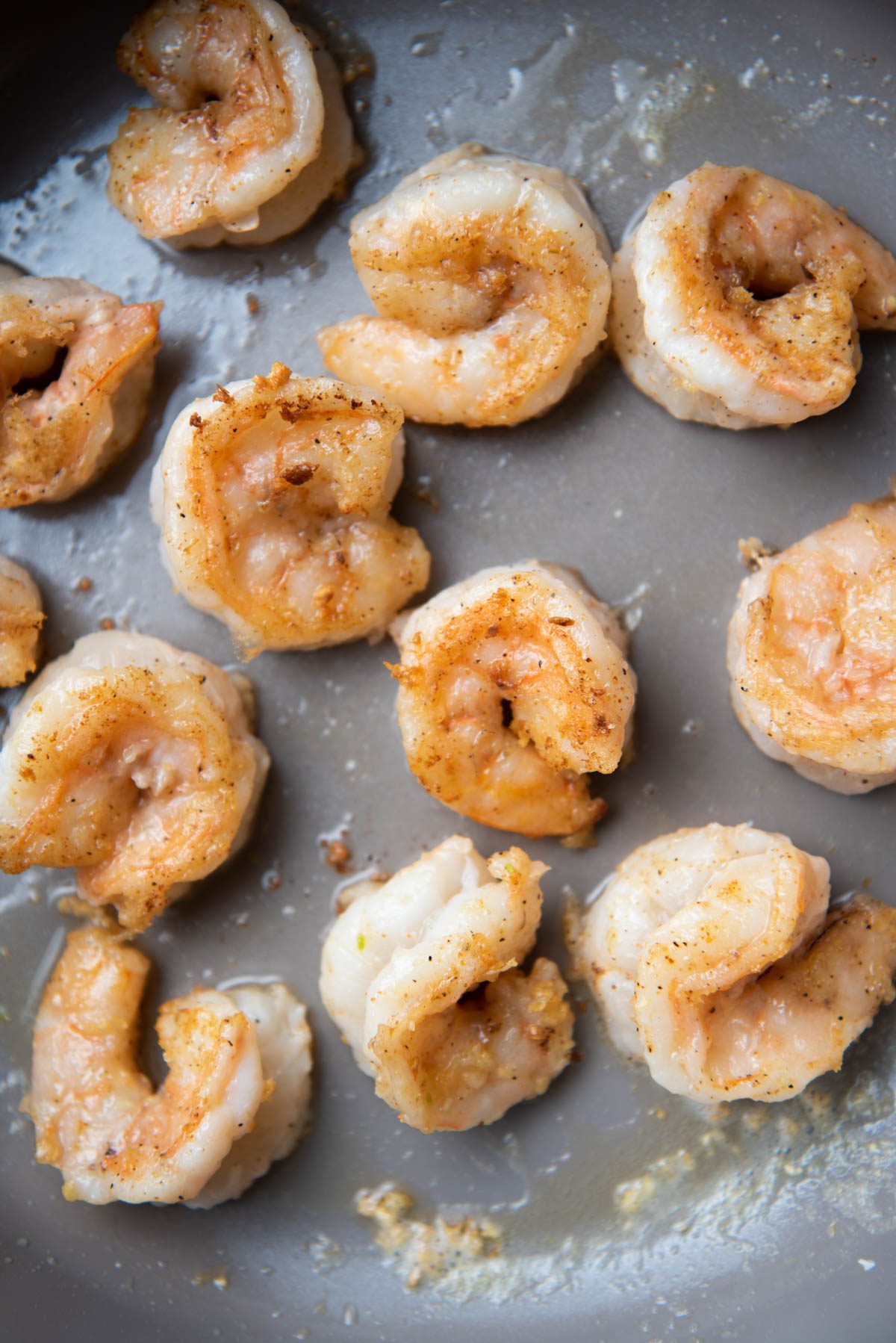 Shrimp in pan with garlic and butter.