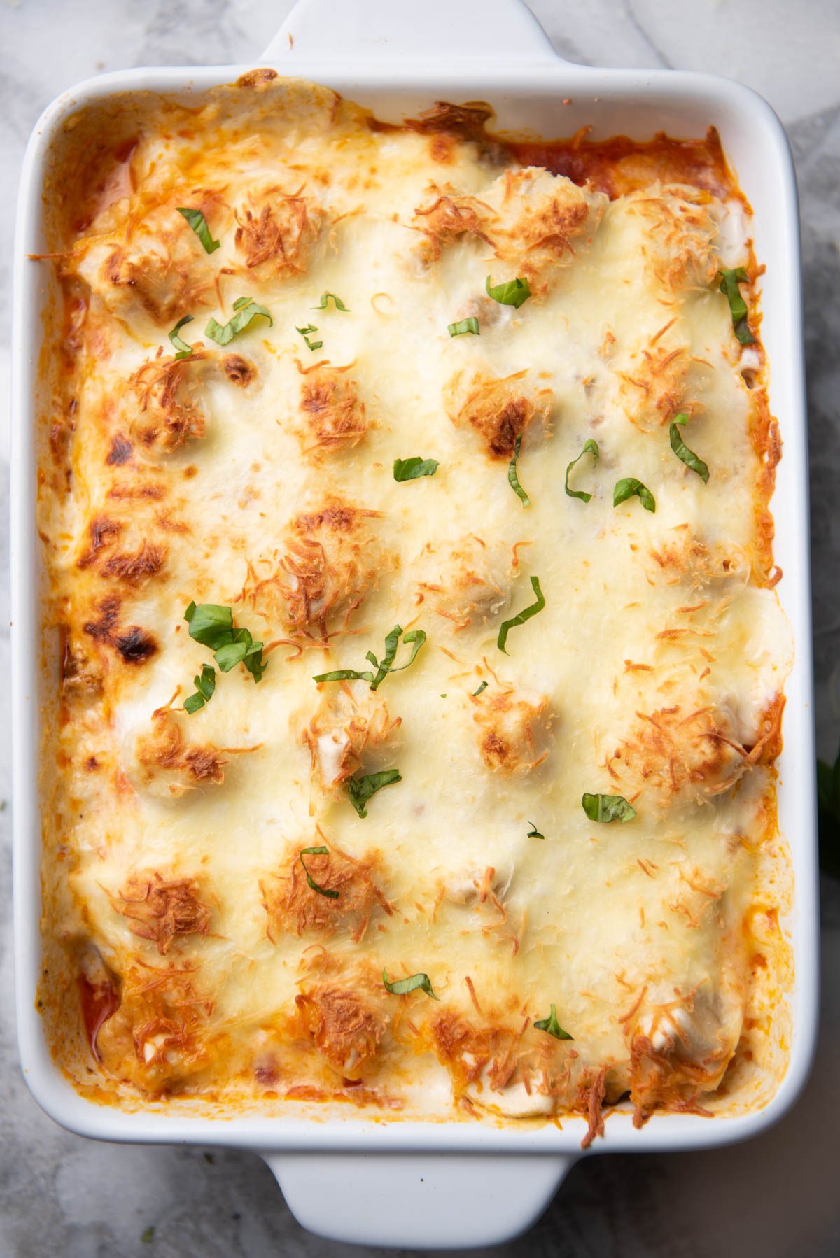 Tortellini baked in a white dish.