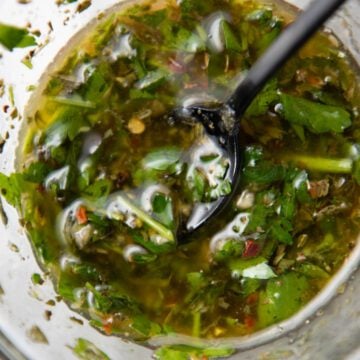 Argentinian chimichurri in a jar with a spoon.