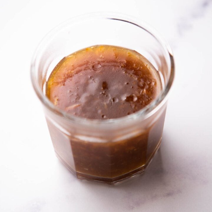 Orange sauce with orange marmalade in a glass jar.