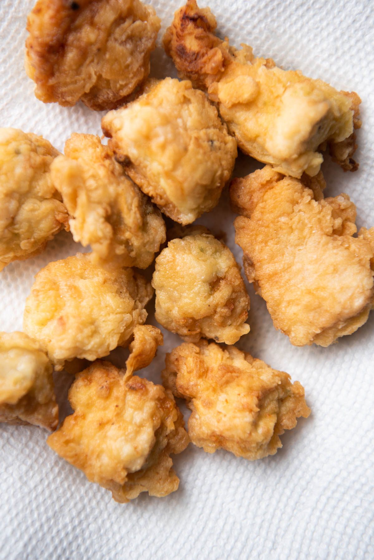 Crispy chicken pieces on a paper towel.