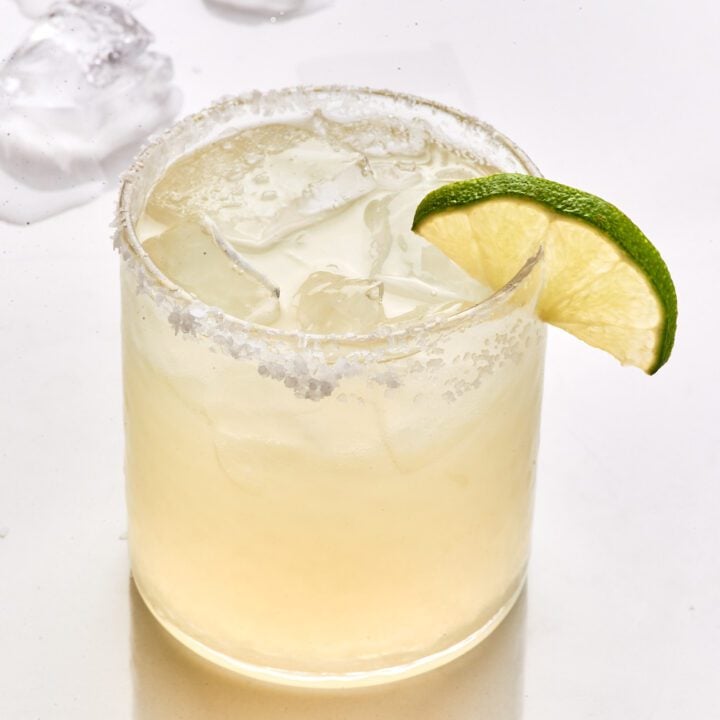 Classic margarita on a glass with lime wedge.