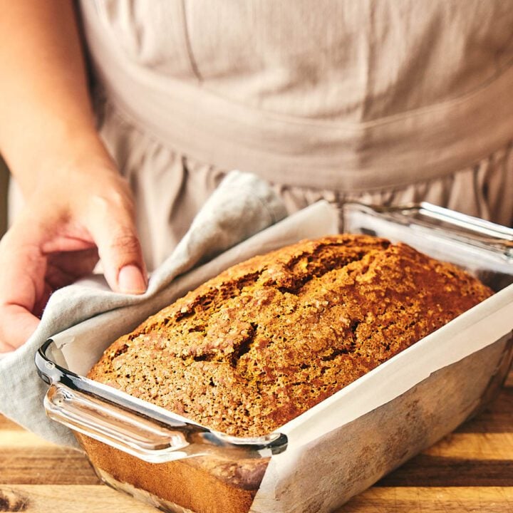 Pumpkin bread on a glass baking dish.