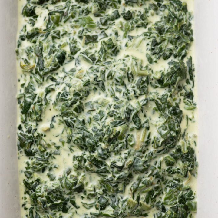 Easy creamed spinach with Boursin cheese in a baking dish.