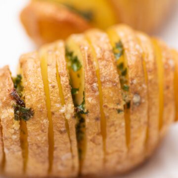 Hasselbak potatoes with herbed butter.