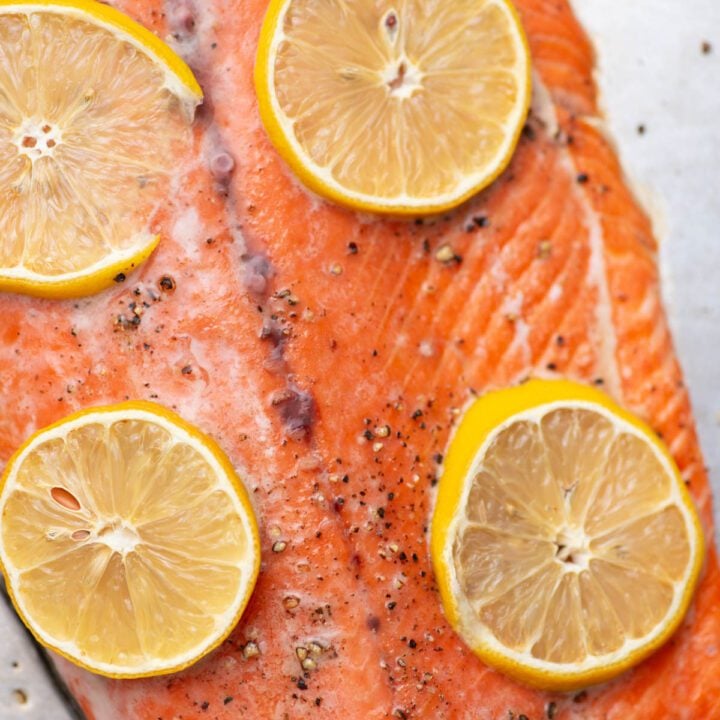 Baked sockeye salmon with lemon slices.