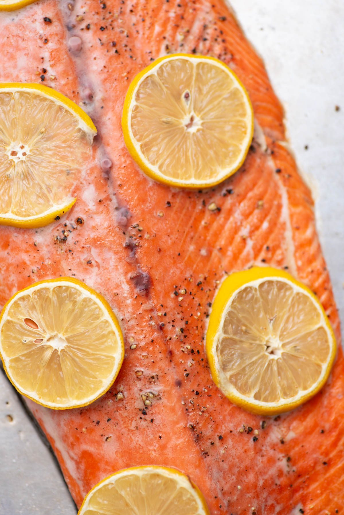 Baked sockeye salmon with lemon slices.