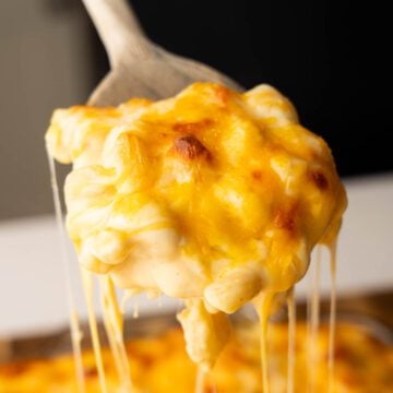 Tini's Mac and cheese being scooped out of casserole dish.