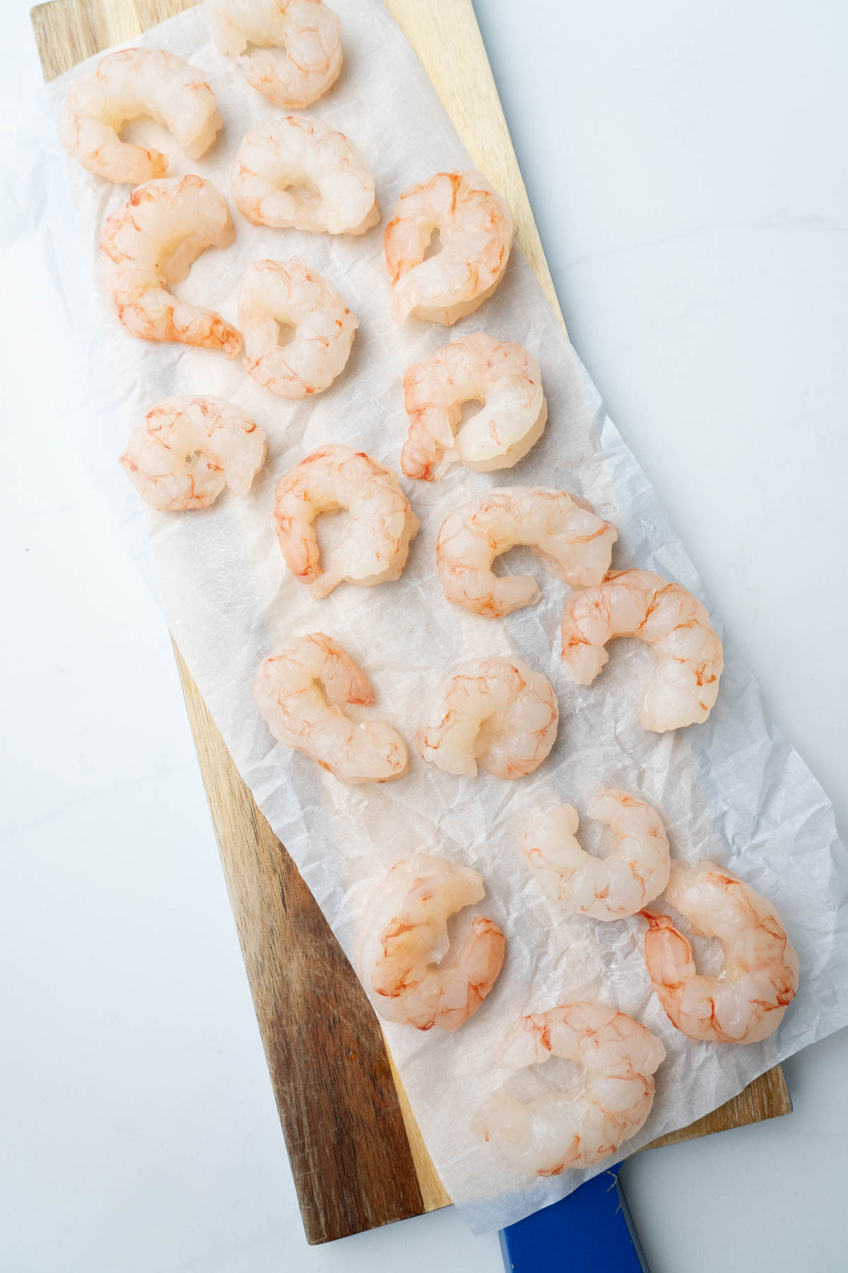 Red argentinian shrimp on a wooden board.