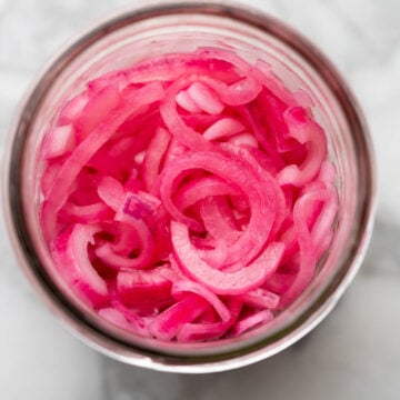 Crunchy pickled onions in a mason jar.