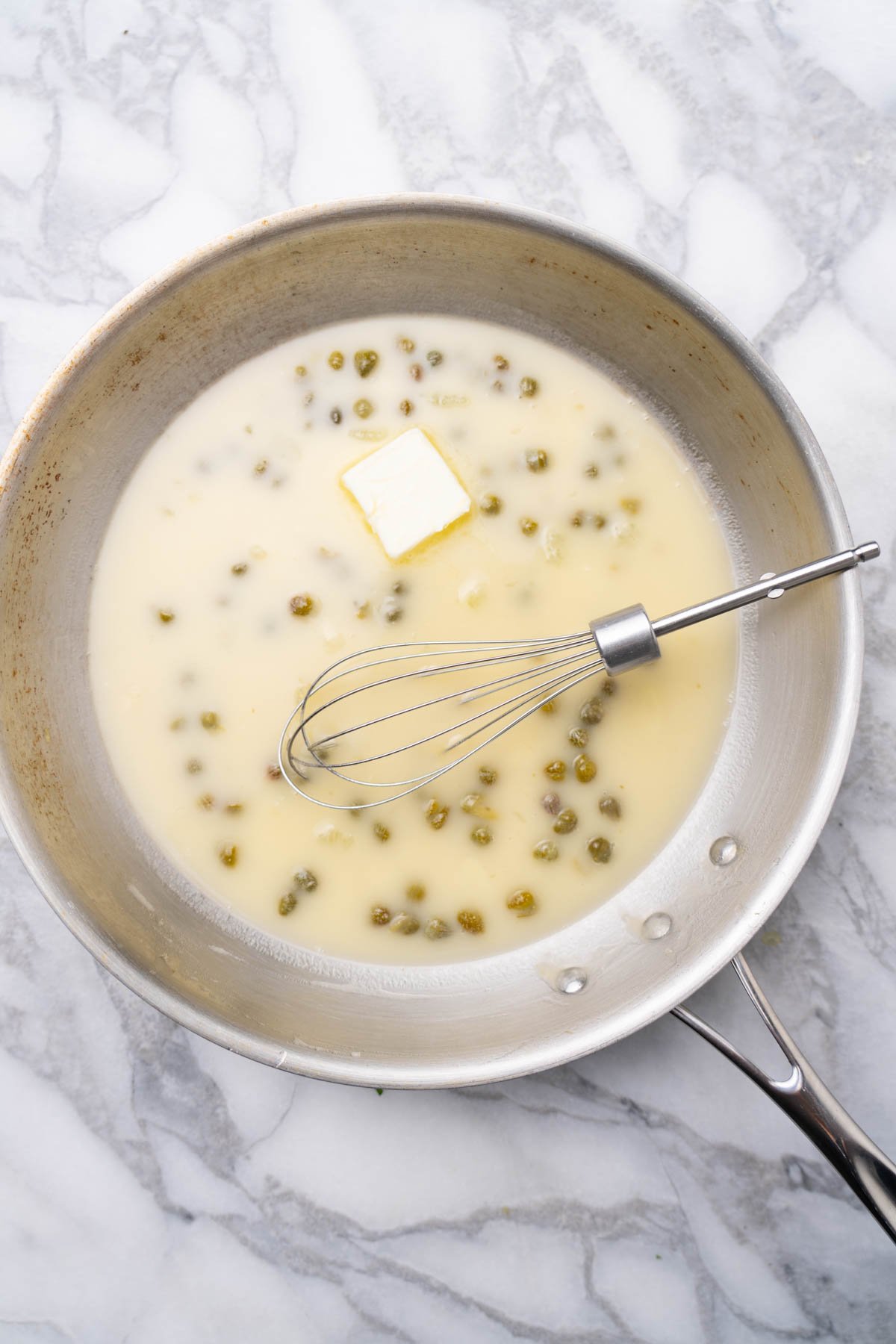 Piccata sauce in a skillet.