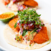 Salmon tacos over corn tortillas with habanero salsa and micro cilantro.
