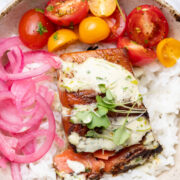 Salmon bowl with rice, tomatoes, onions and aioli.