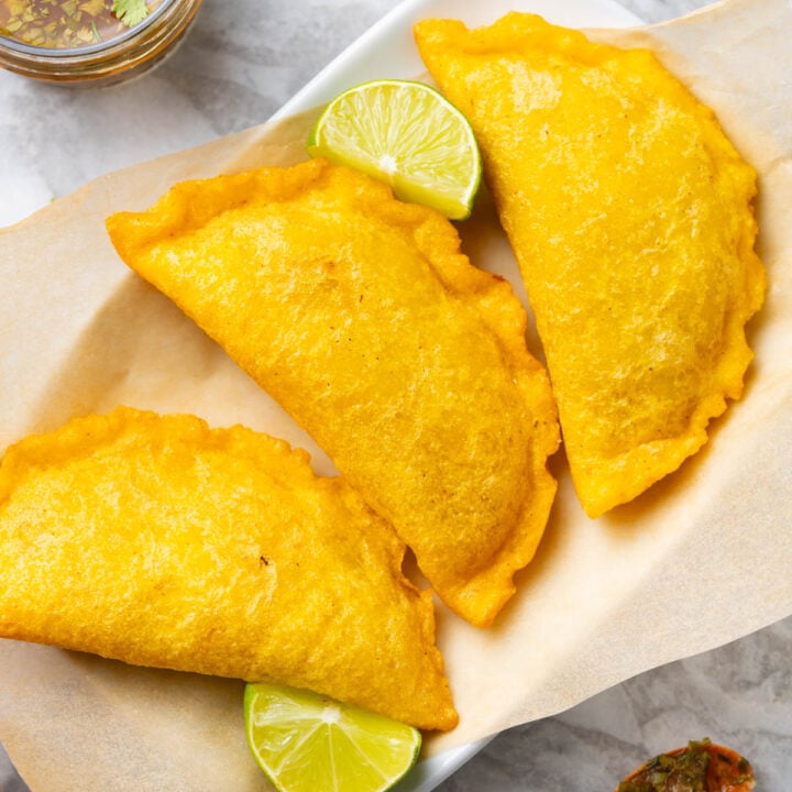 Colombian empanadas with aji sauce and lime.