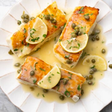 Halibut piccata on a plate.
