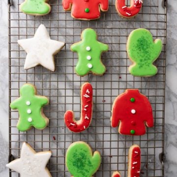 Sugar cookies with royal icing on a baking rack.