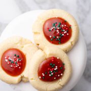 Jam thumbprints in a cookie plate.