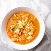Tiny star pasta soup (Stelline soup) garnished with fresh parsley.
