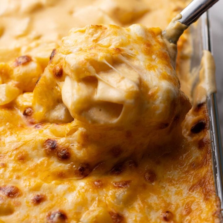 Cheesy potato casserole with a spoon.