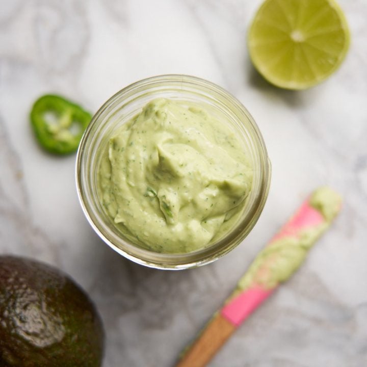 Ingredients to make avocado cream sauce including lime, jalapeño and avocado.