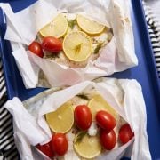 Cod in parchment paper with lemon and tomatoes.