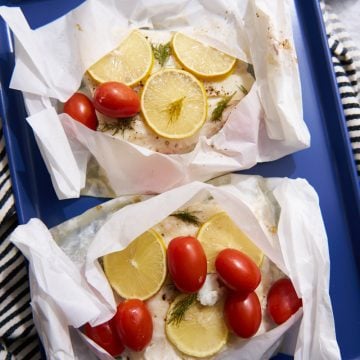 Cod in parchment paper with lemon and tomatoes.