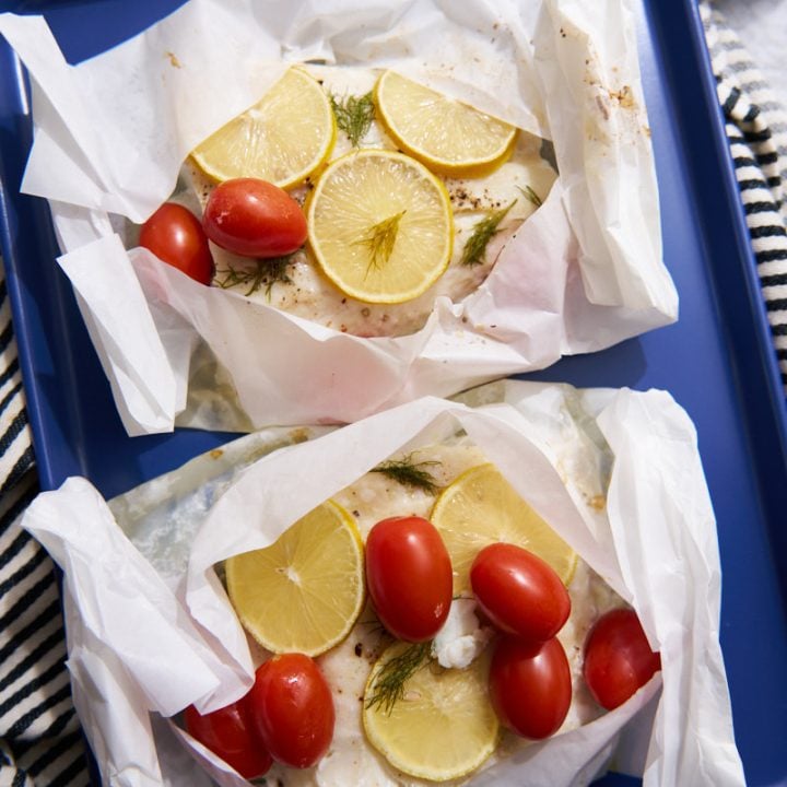 Cod in parchment paper with lemon and tomatoes.