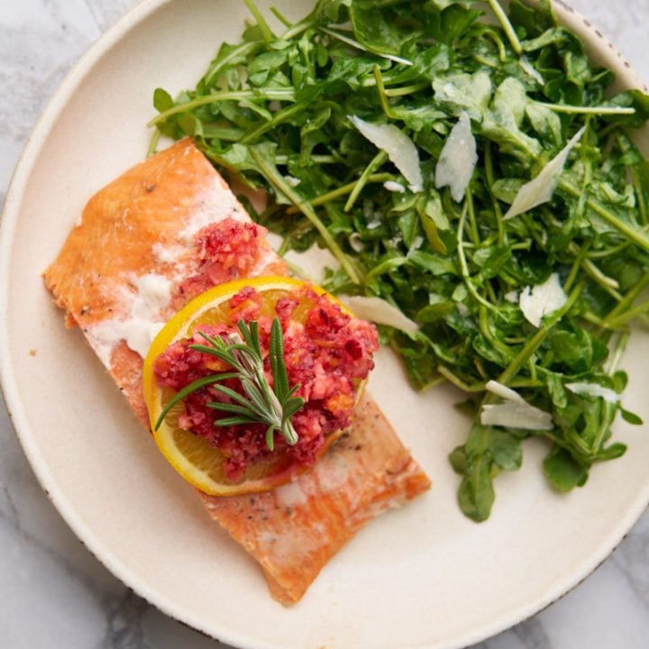 Baked salmon with cranberry orange relish served with arugula salad.