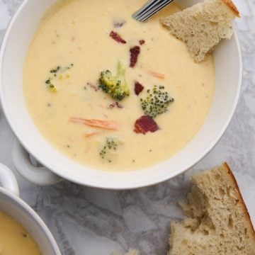 Viral broccoli cheddar soup with bacon. Served in a bowl with some bread.