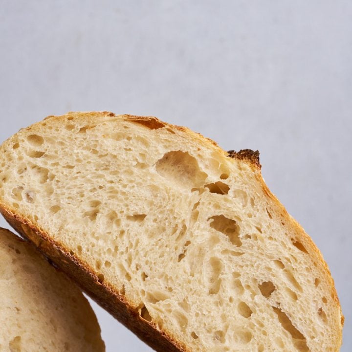 Sourdough bread sliced in half on a cutting board.