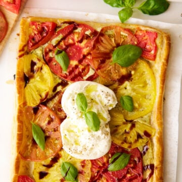 Tomato puff pastry tart with burrata and balsamic glaze.